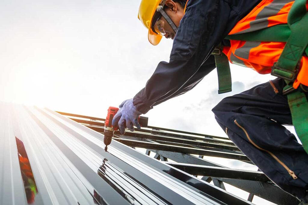 Homeowner inspecting a roof edge from a secured ladder on a clear, dry day
