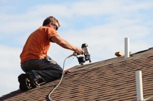 Home gutters carry rainwater from a shingled roof through downspouts away from the foundation.