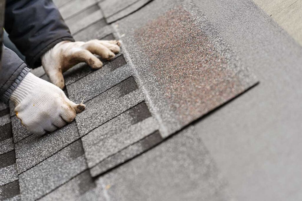 Gutters and downspouts carrying rainwater away from a sloped residential roof.
